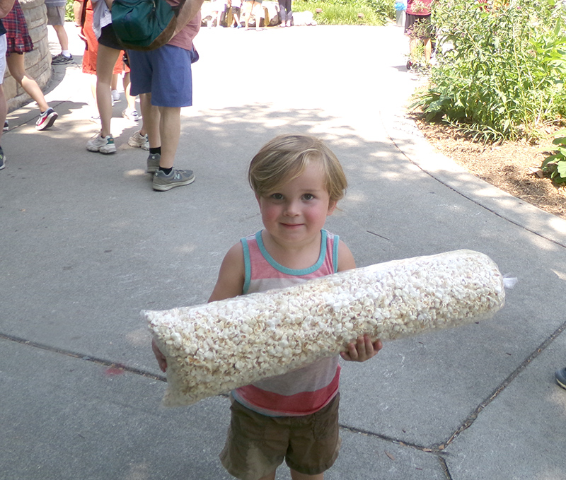 Corbin, age 2, with a huge bag of popcorn