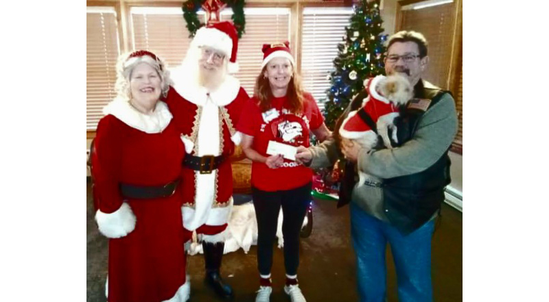 (L-R) Mrs. Claus (Noel Kringle), Santa Claus (Kris Kringle) President Melissa Clawson, and holding Santa Dog (Benji Kringle) Commander Ely Hinkle of the ALR 