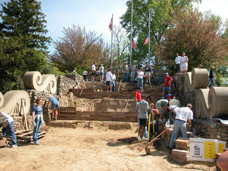 Dozens of volunteers dig out the dirt and build tiers for plantings.