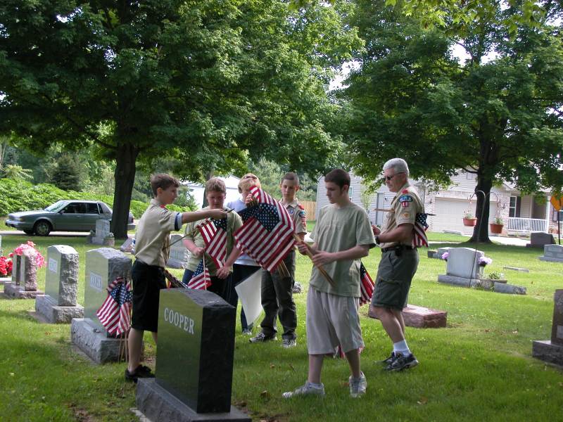 American flags are passed out to the Boy Scouts of Troop 18 to decorate veterans' graves at Union Chapel cemetery, near 8300 Haverstick Road.