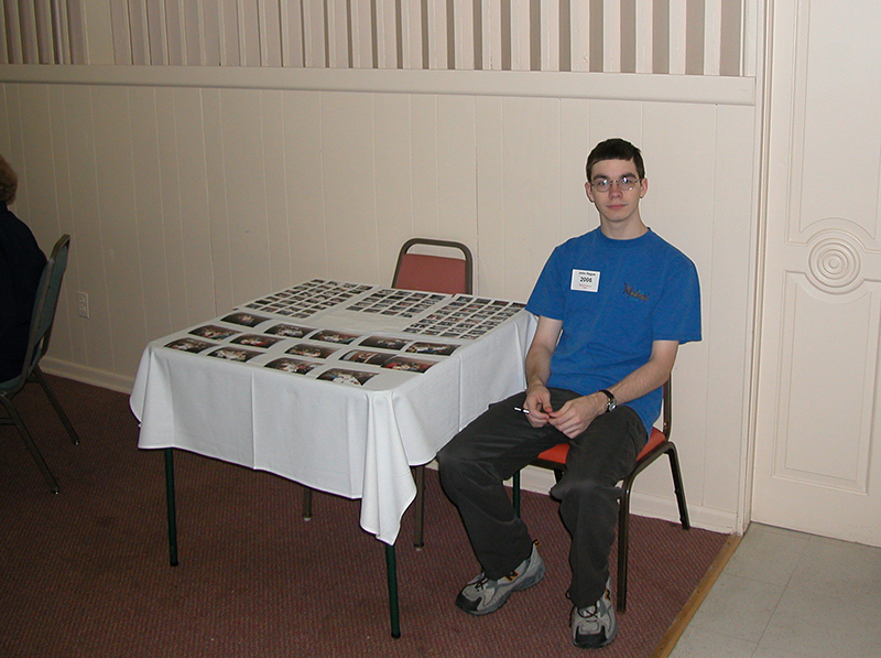 John Samuel Hague at the table of photos from the 2003 reunion