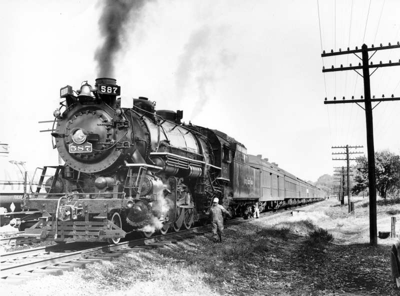 Road Foreman W.G. Yettman running along side the 587 with oil can in hand.