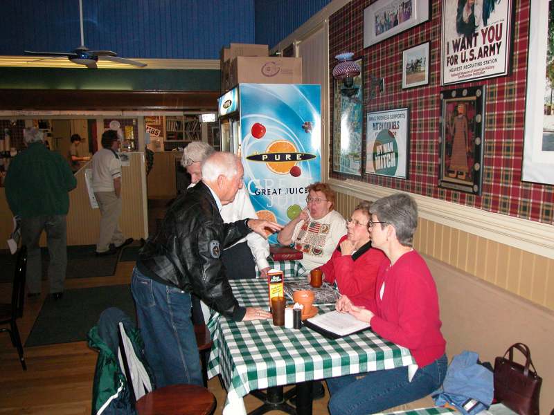 Bob Hindman standing, talking to Mrs. Edie and Elizabeth Hague.