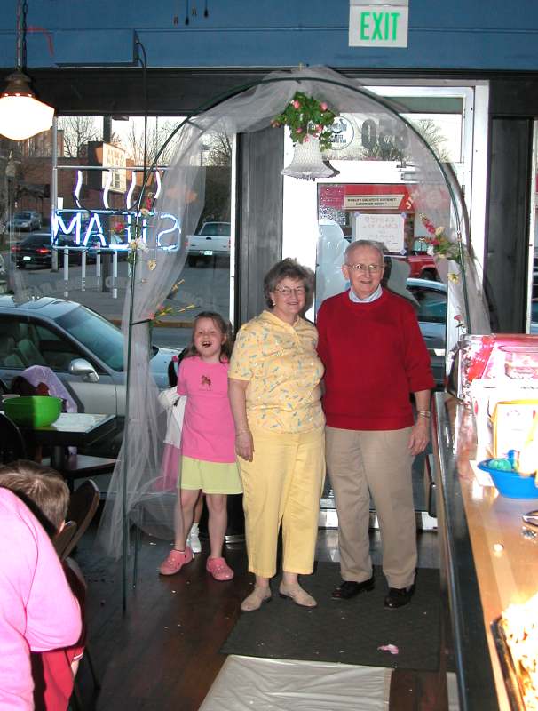 Tom and Christine come through the archway at the wedding rehearsal.