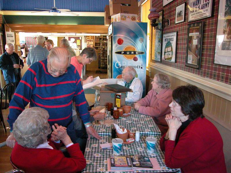 At first table Bob Frazier (standing), Mary Frances VanDerMeulen, Laura Heidenreich