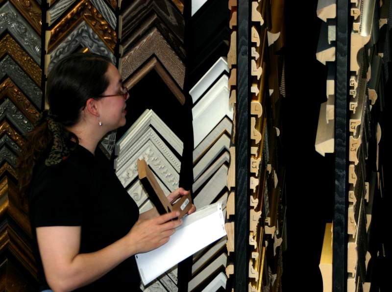 Robin picks out a picture frame from the sample wall.