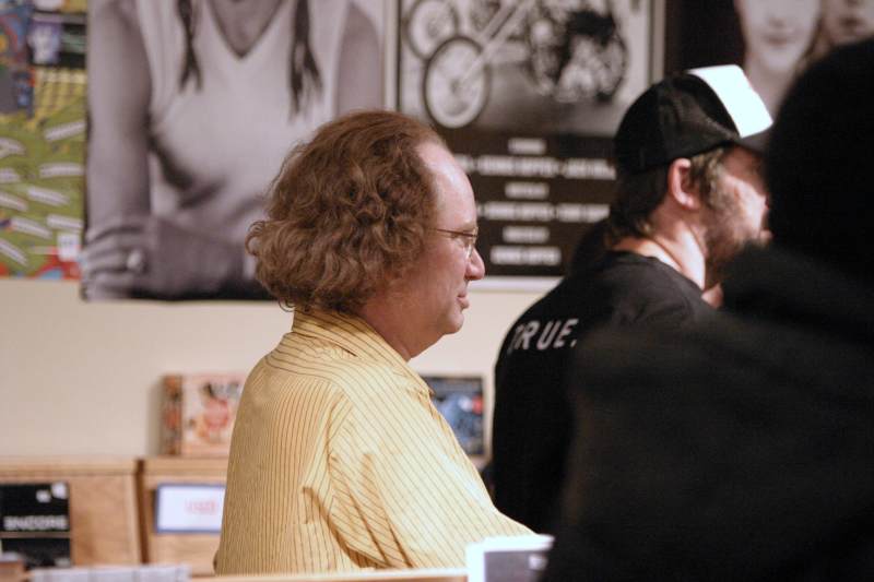 Store owner Rick Zeigler listens during the local band marathon at Indy CD and Vinyl, Saturday April 30th, 2005.