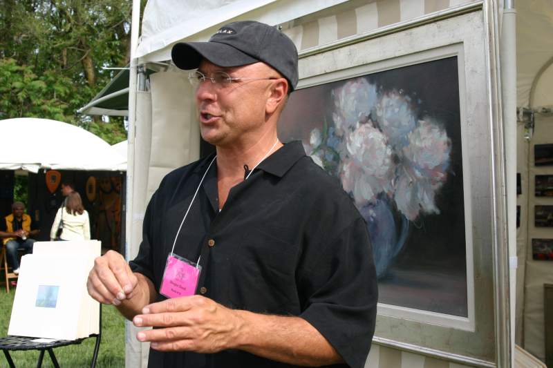 Douglas David in front of one of his peony paintings.