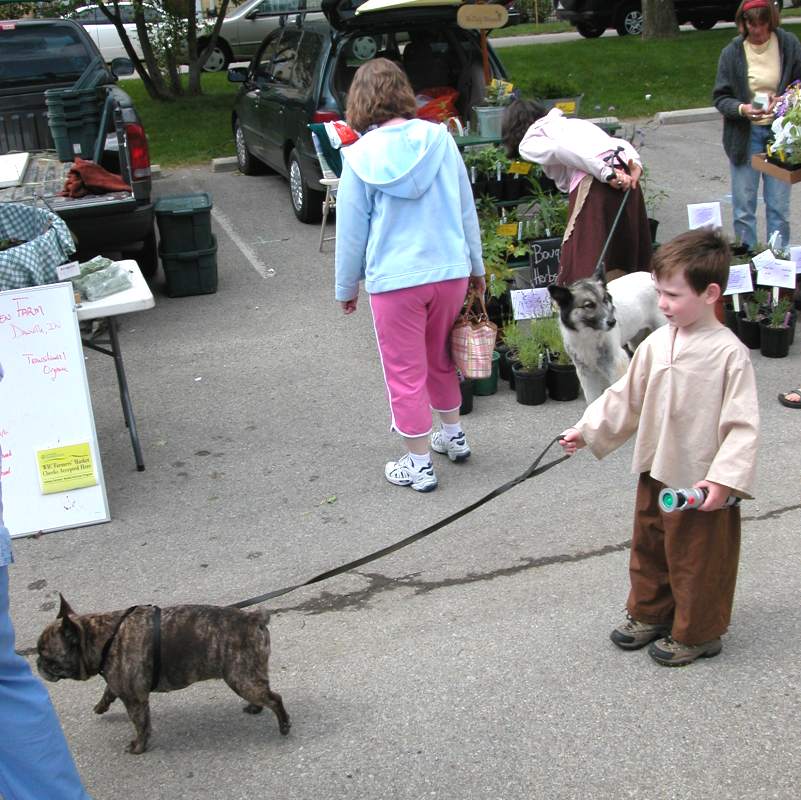 A young Jedi with his lightsaber and his dog.