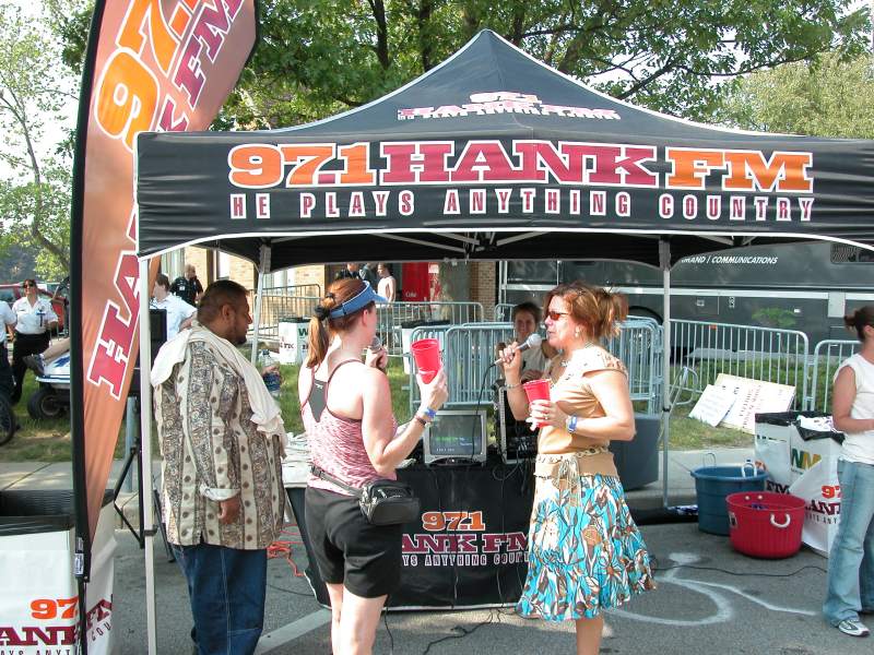 Singing karaoke at the 97.1 HANK FM tent for a t-shirt.