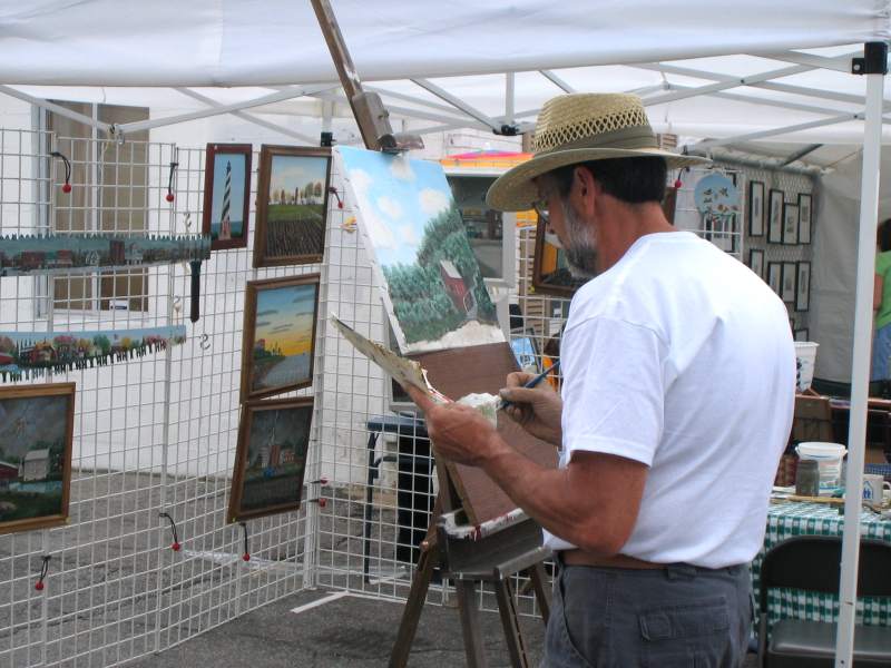 Walt Thacker painted a landscape at the fair.