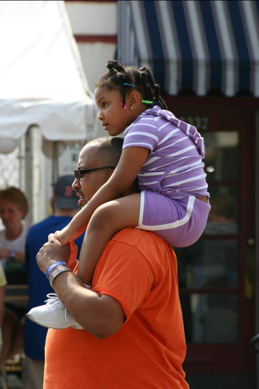 The best seat in the house is on dad's shoulders.