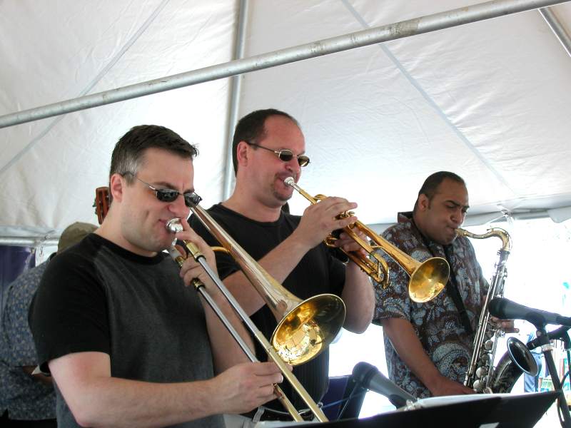 The horn section of Mina Keohane: Brent Wallarab on trombone, Mark Buselli on trumpet, and Rob Dixon on saxophone.