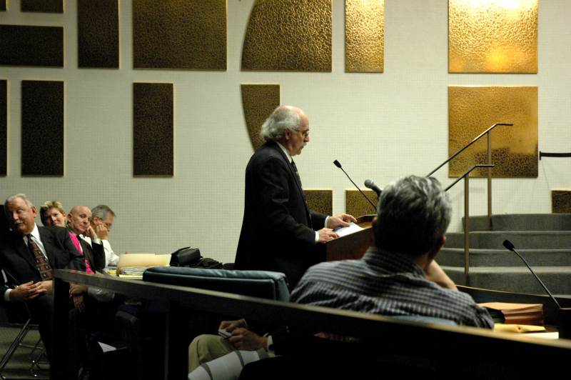 David Kosene listens as Jim Holland presents the case for the remonstrators.