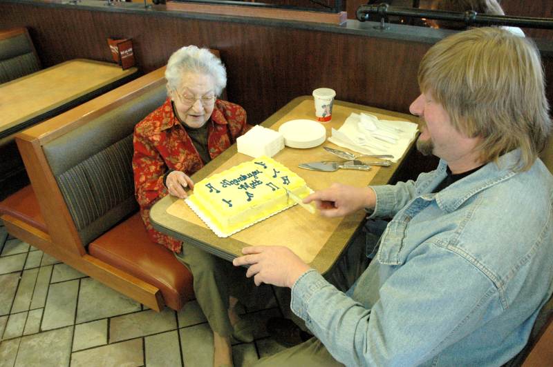 Matt Stokes cutting the cake Dorothy Thacker brought to his last music program.