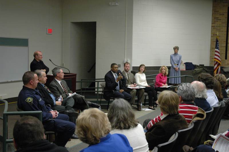 NUVO's David Hoppe (behind the podium) listens as the panel responds to questions from the audience.