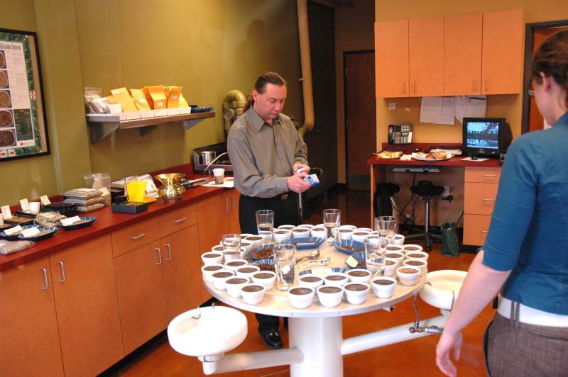 Jerry Cravens measures the coffee temperature to determine the optimum time for the cupping.