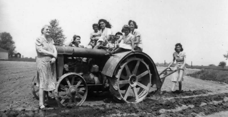 The Featherston family gathered on the tractor.