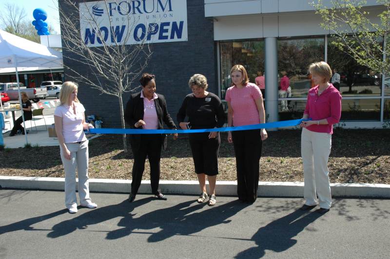 Forum Credit Union branch manager Michelle Isaac watched BRVA president Ellen Morley Matthews cut the ribbon at the grand opening.