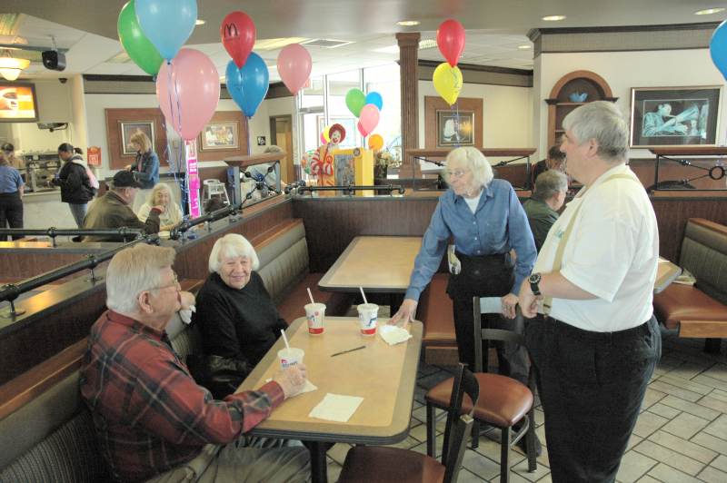 Mary LaForge (standing) talking to some of her friends at McDonald's.