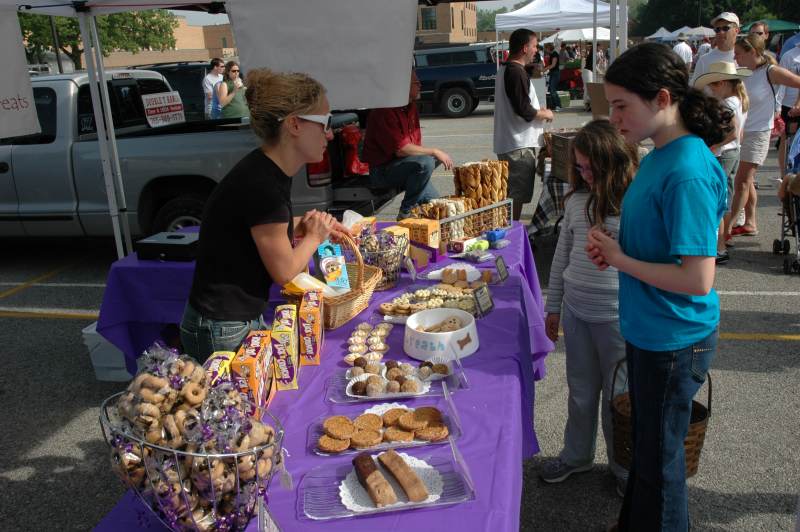 Stacey Petcu of Three Dog Bakery helped these girls pick just the right doggie treat at the Broad Ripple Farmer's Market.