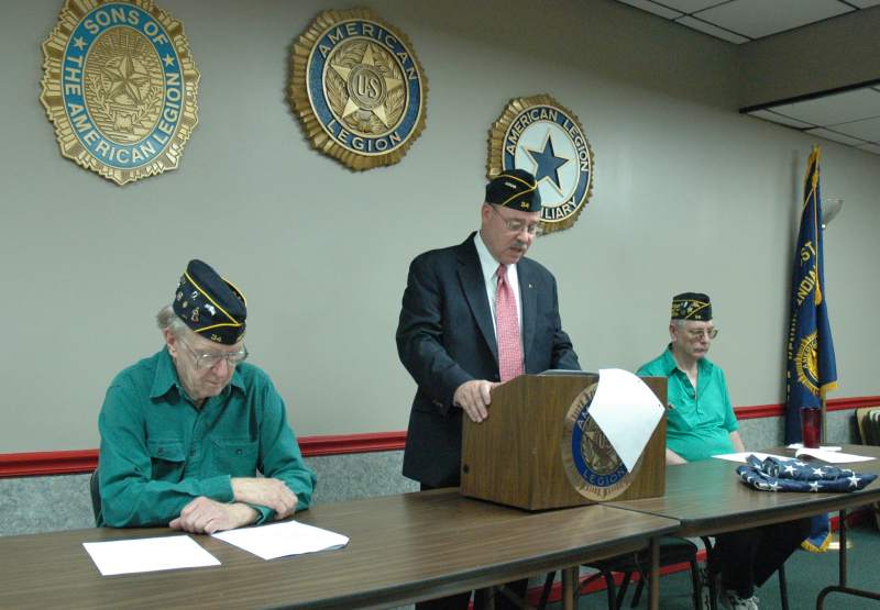 Commander Gary Price (standing), adjutant Jerry Timmons and chaplain Wes Spang.