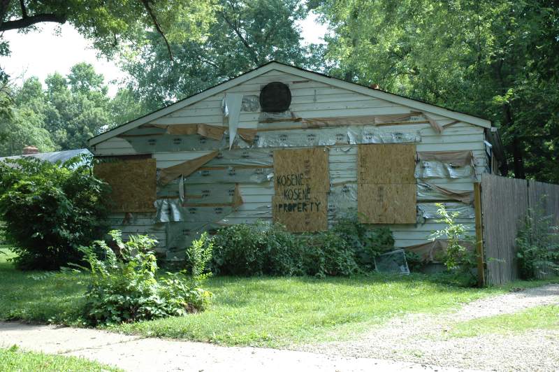 The street side view of the property. Neighbors are asking why these properties have been left in this condition for so long.