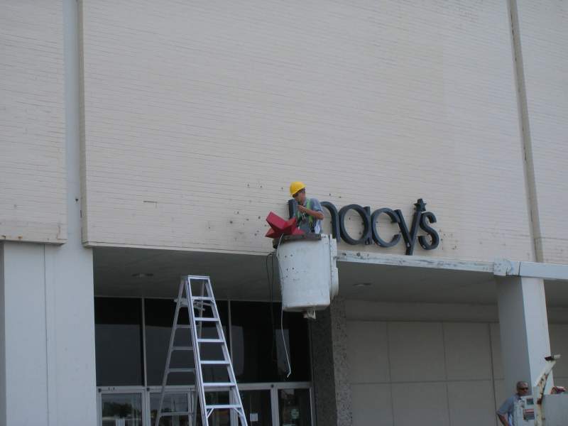 The new Macy's signs were installed on the Ayres facade, and then were quickly covered by temporary Ayres signs.