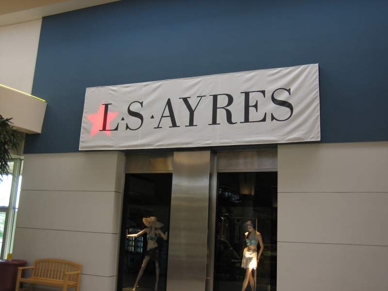 The red star of the Macy's signs shows through the Ayres banner.