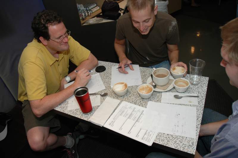 The judges, Brian, Chris, and Joe, contemplate the artistic merits of each latte.