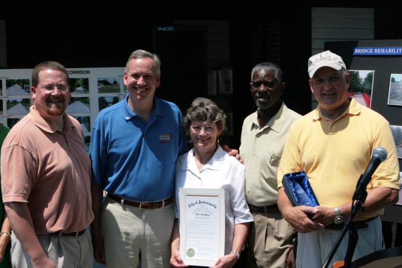 Matthew Klein, Bart Peterson, Peggy Boehm, Joe Wynns, and Ray Irvin pose for a group photograph, including the Proclamation from Mayor Peterson in honor of the 10th anniversary of the Monon Trail.