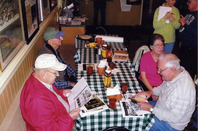 Bill Wendling (lower right) at a 2004 History Saturday meeting at The Whistle Stop. Across from Bill is Wally Scott. The Kassebaums are next to them.