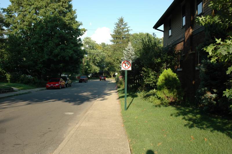 New signs indicate that parking is now only allowed on the north side of Paxton Place between Carrollton and Guilford.