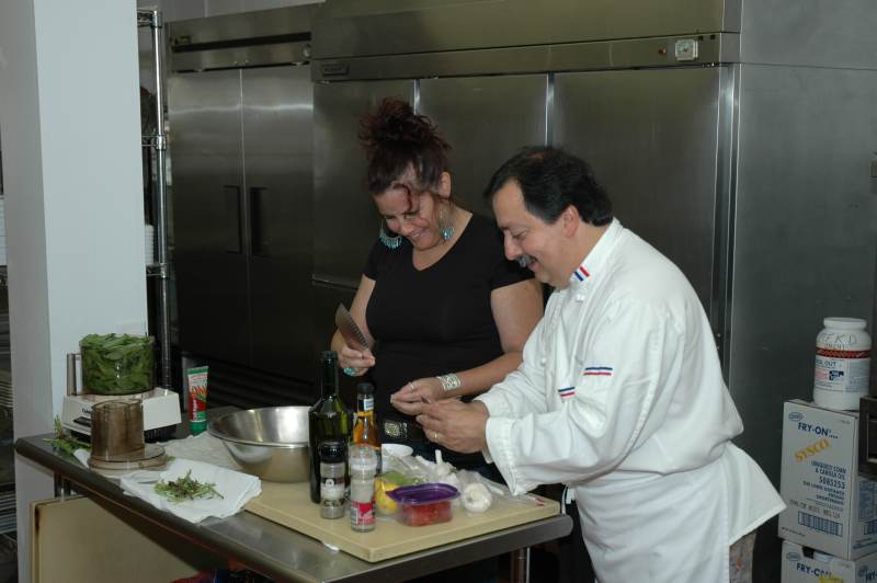 Zest! owner Valerie Vanderpool assists Chef Prosper in the kitchen.
