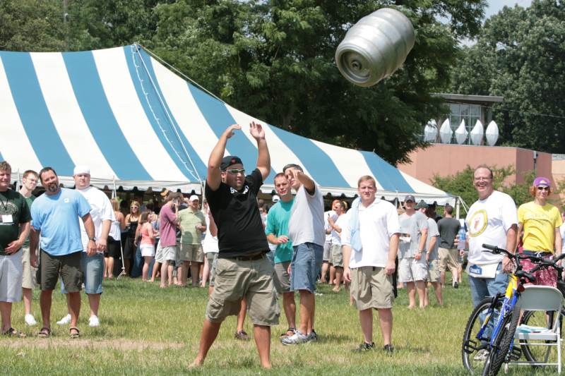 A crowd gathers to watch the Keg Toss at the Indiana Microbrewers Fest in Opti Park.