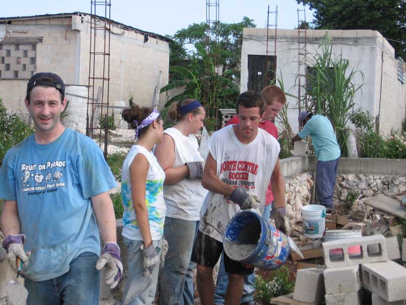 Peter Hunter from Northminster Presbyterian Church pours cement at North Quintana Roo Church building project.