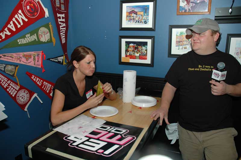 Mikey from the 93.1 Morning Mess watches as Brandi from The Aristocrat works on her third and last pickle of this round.