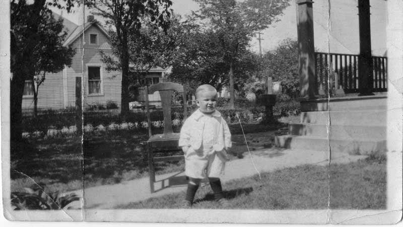 Wally Scott in 1922 in front of his house on Ferguson. The house in the background is now the restaurant L'Explorateur.