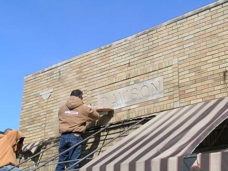 The stone mason cut the Dawson stone from the facade of Broad Ripple Refinishing.