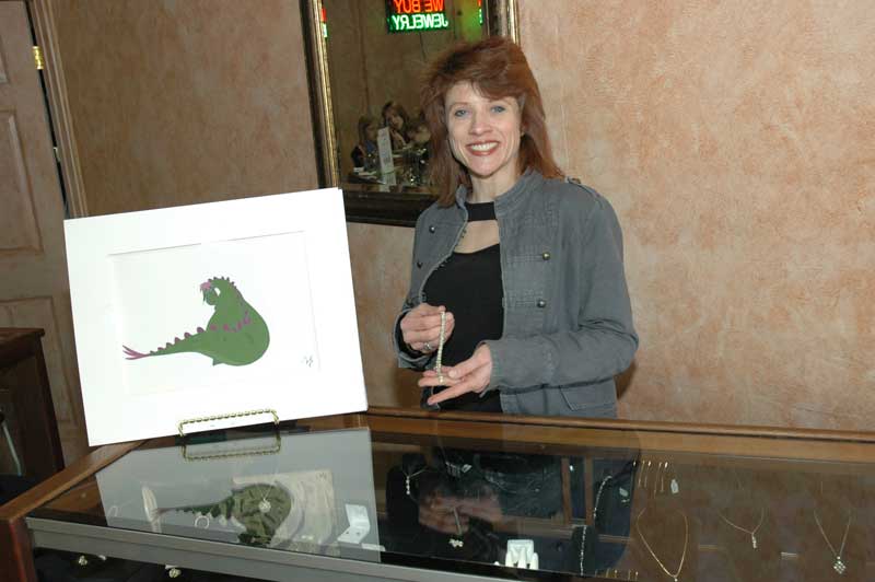 Bling owner Allyson Levin poses in her new store with an original animation cel and some bling. 