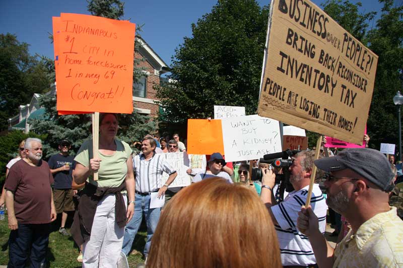 Protestors on July 7. The third sign from the right is promoting the sale of a taxpayer's kidney.