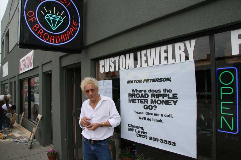 William Levin, owner of Bling! takes action outside his shop on Broad Ripple Avenue.