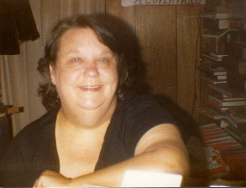 June Sublett, with books in the background.