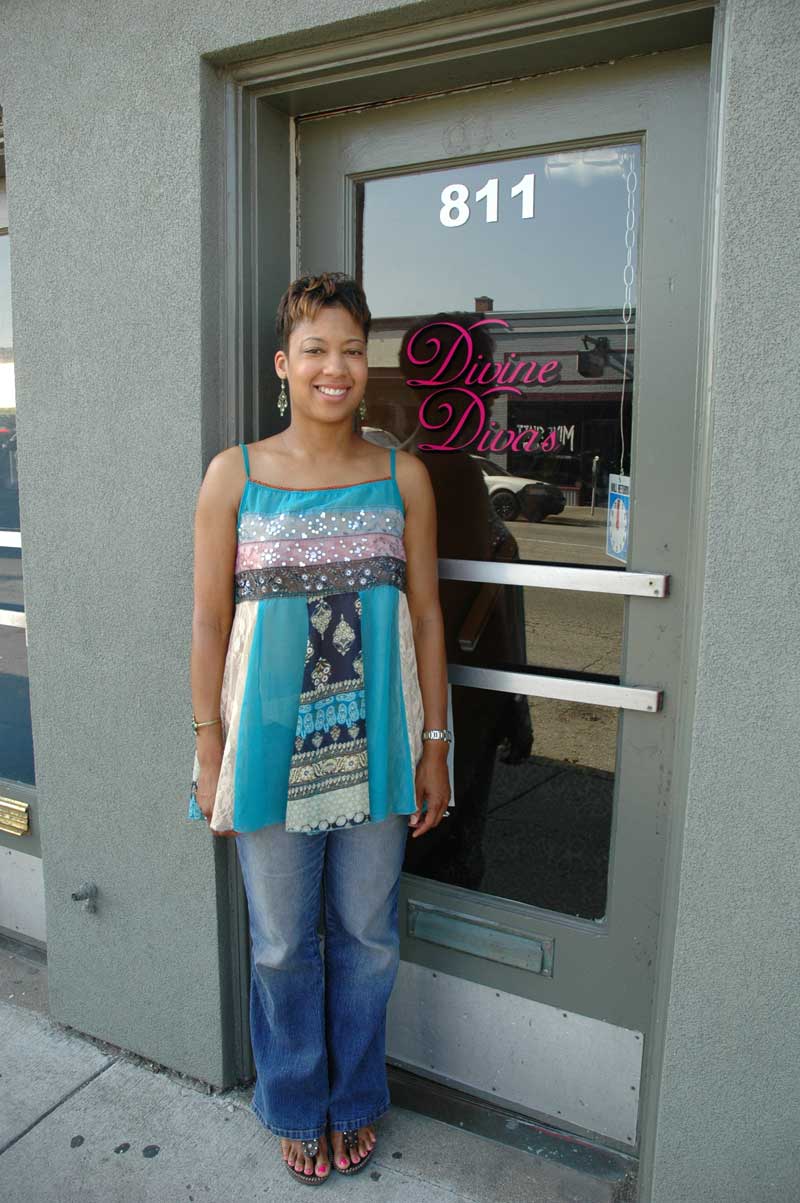 Owner Racquel Woods stands in front of the Divine Diva entranceway.