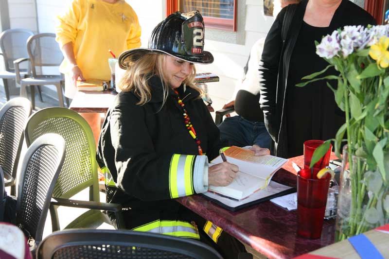 Kathy Gillette signs her new book for a fan on Sept. 11.