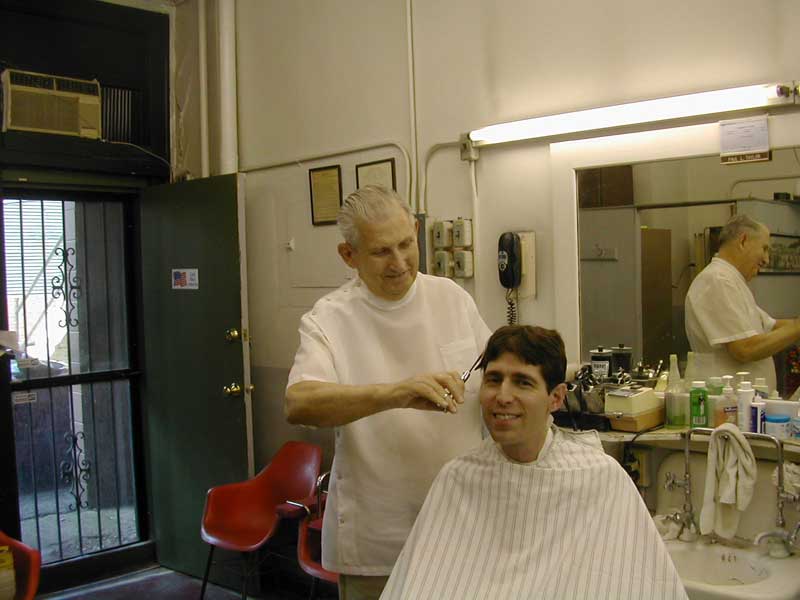 Showing his skills: Gazette writer Mario Morone gets a haircut from Paul Taylor at his Barber shop on 52nd street. 