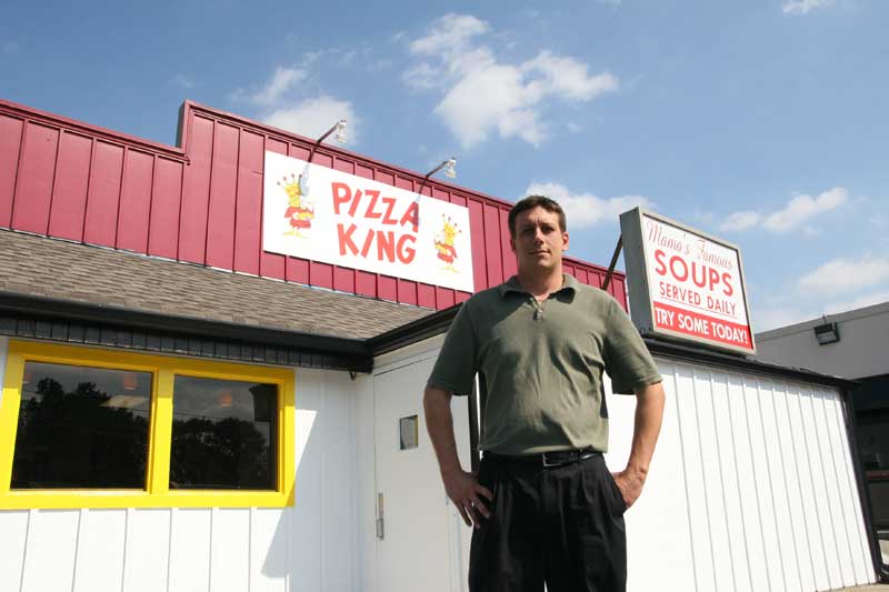 Manager Carl Truby stands proudly in front of the new Pizza King location in Broad Ripple.