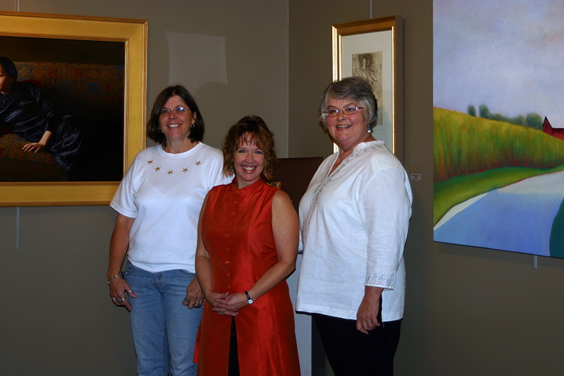 Hoosier Salon Executive Director Amy Kindred stands proudly between two fellow workers of the gallery.