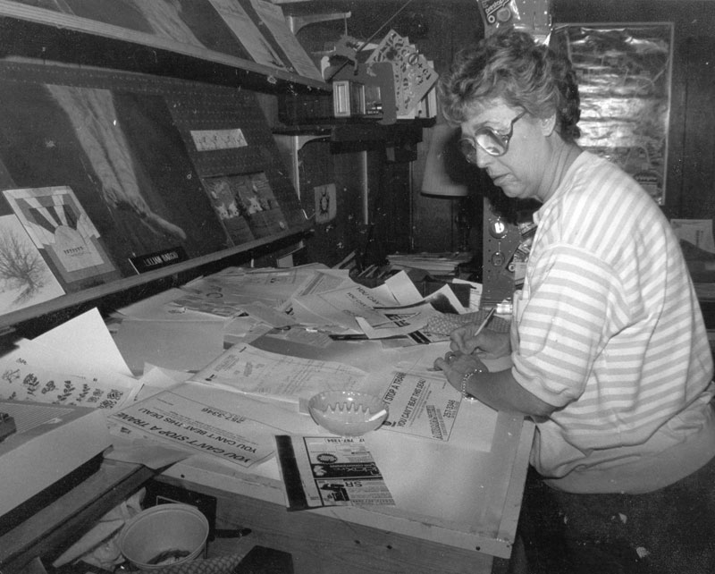 Lillian Barcio working on the layout of the Village Sampler back in the day of light tables and pasteups.