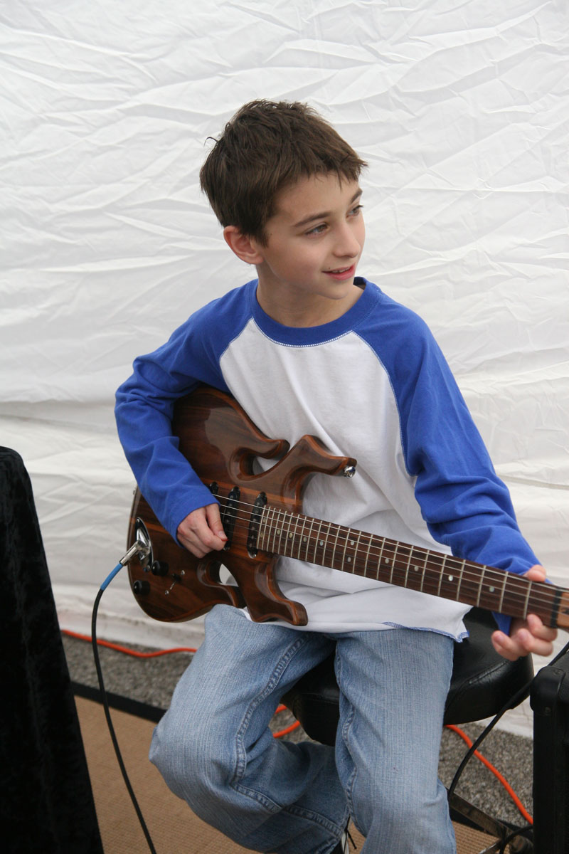 Young and old lined up to try out Erik Smith's handcrafted guitars.